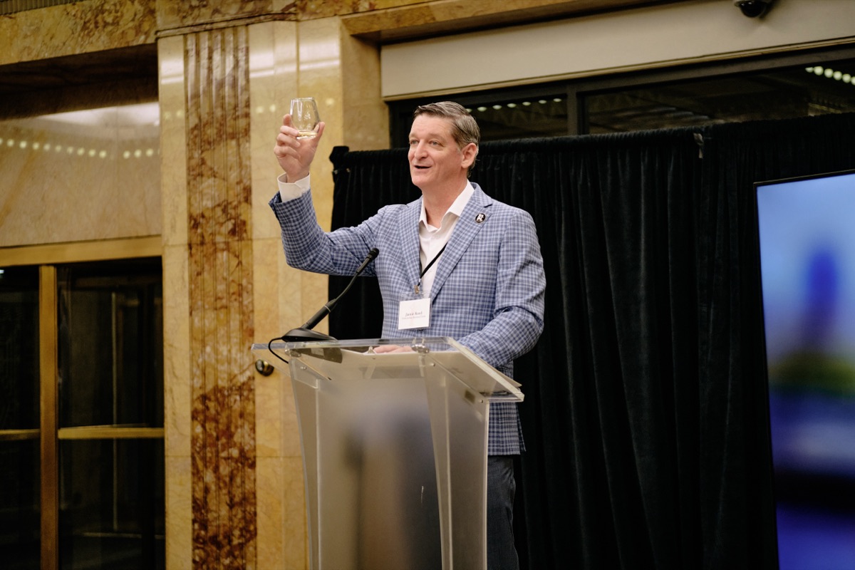 Jamie Rand of Downtown Revival Trust raising a toast in the marble lobby
