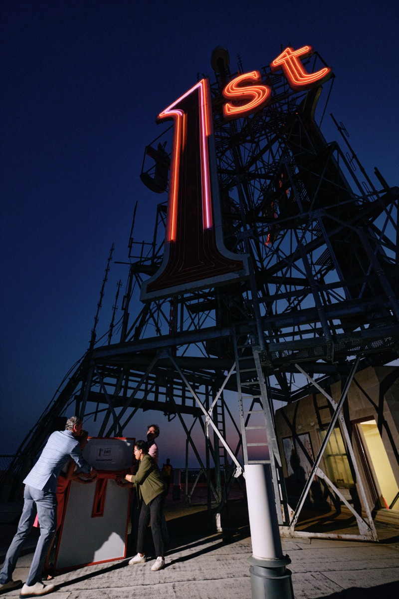 Guests throwing the ceremonial switch beneath the sign tower